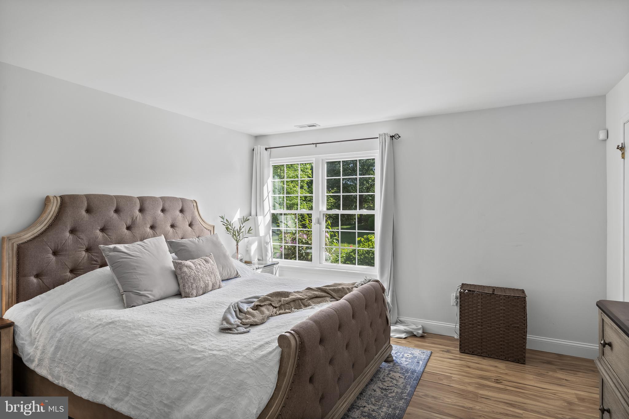 1 Neville Court Sewell, NJ 08080 - Photo 12 of 24 a large bed sitting in a bedroom next to a window with wooden floor