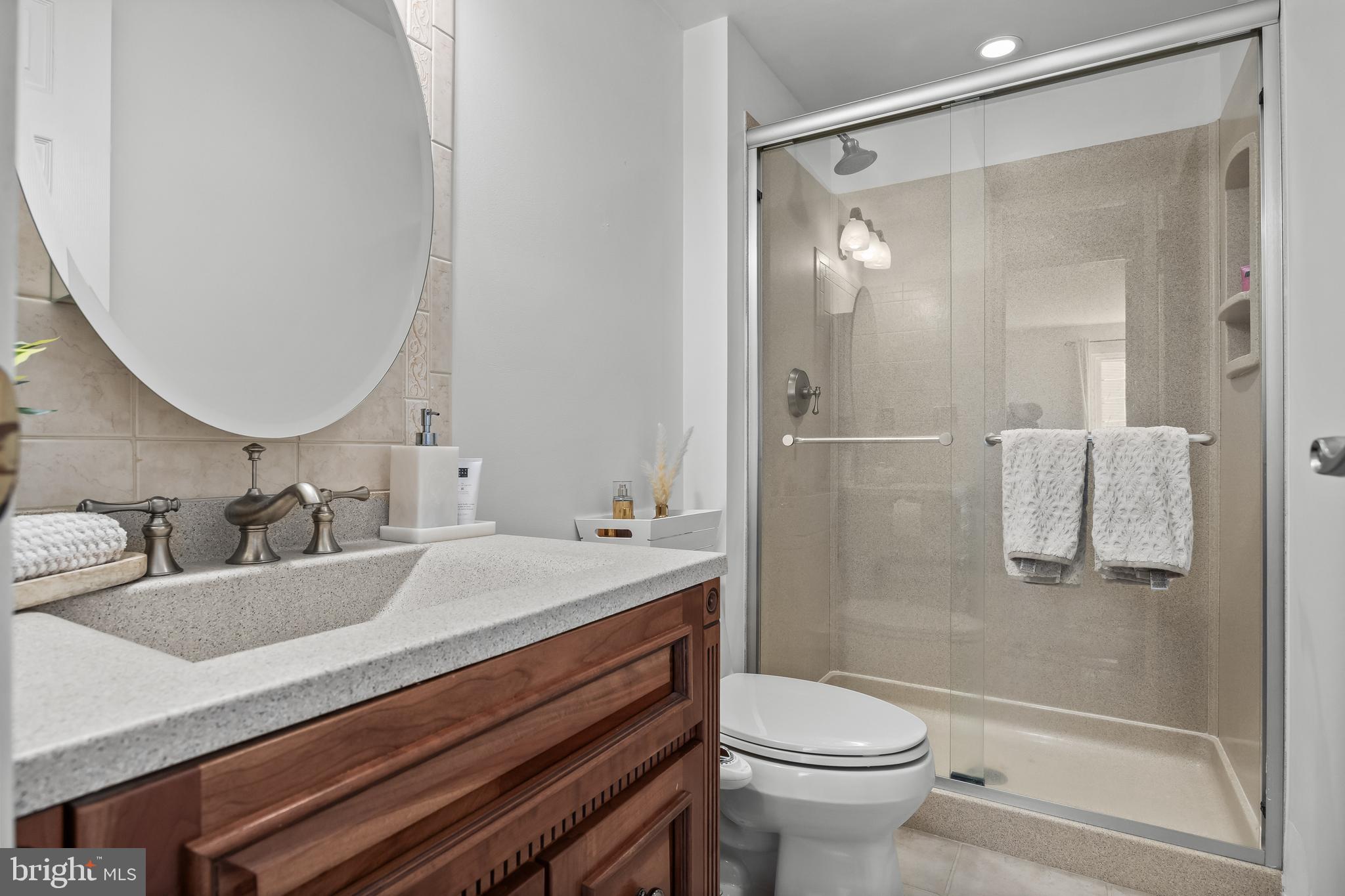 1 Neville Court Sewell, NJ 08080 - Photo 18 of 24 a bathroom with a granite countertop sink toilet mirror and shower