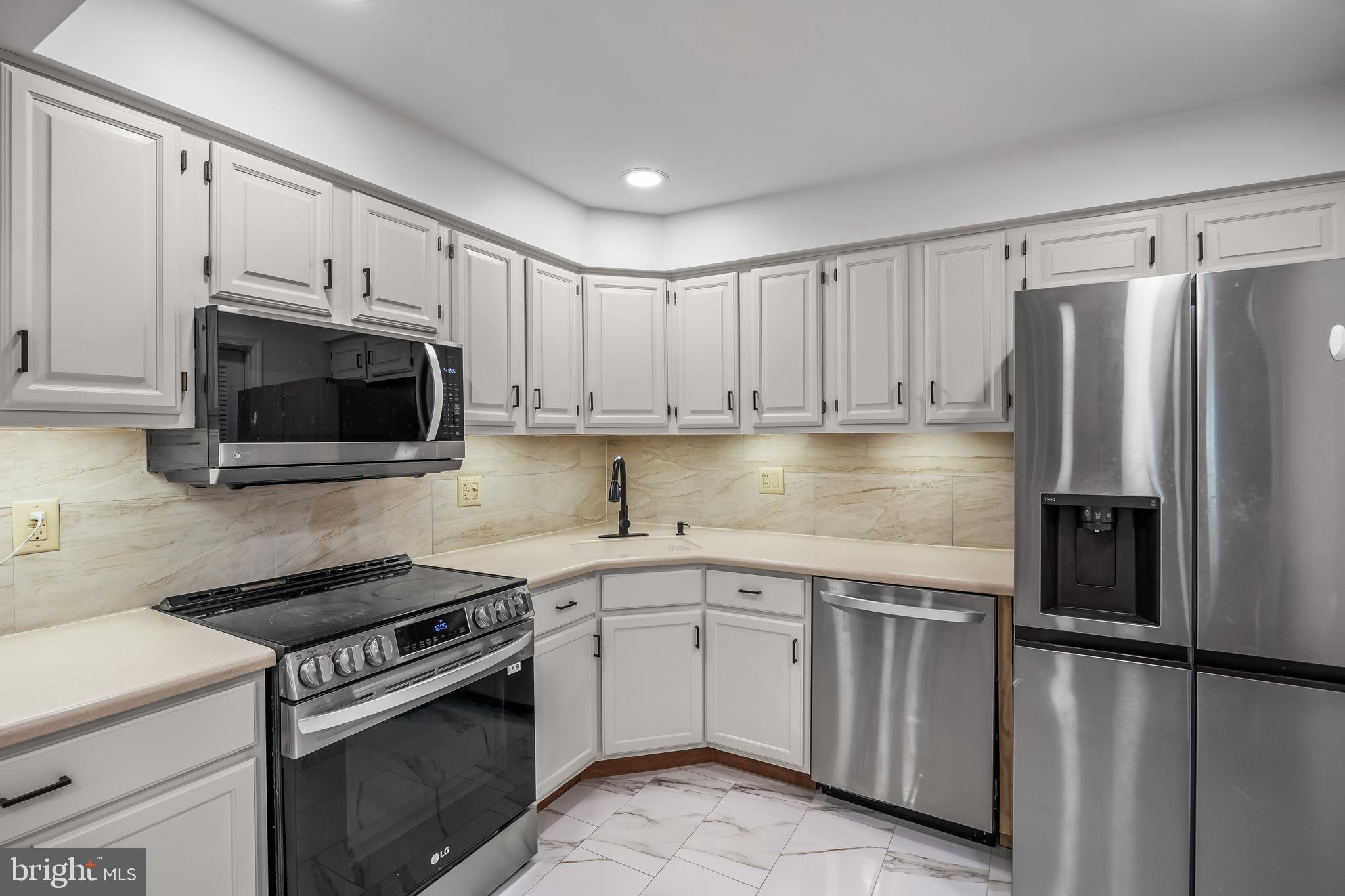 1 Neville Court Sewell, NJ 08080 - Photo 21 of 24 a kitchen with granite countertop a sink a stove a refrigerator and cabinets