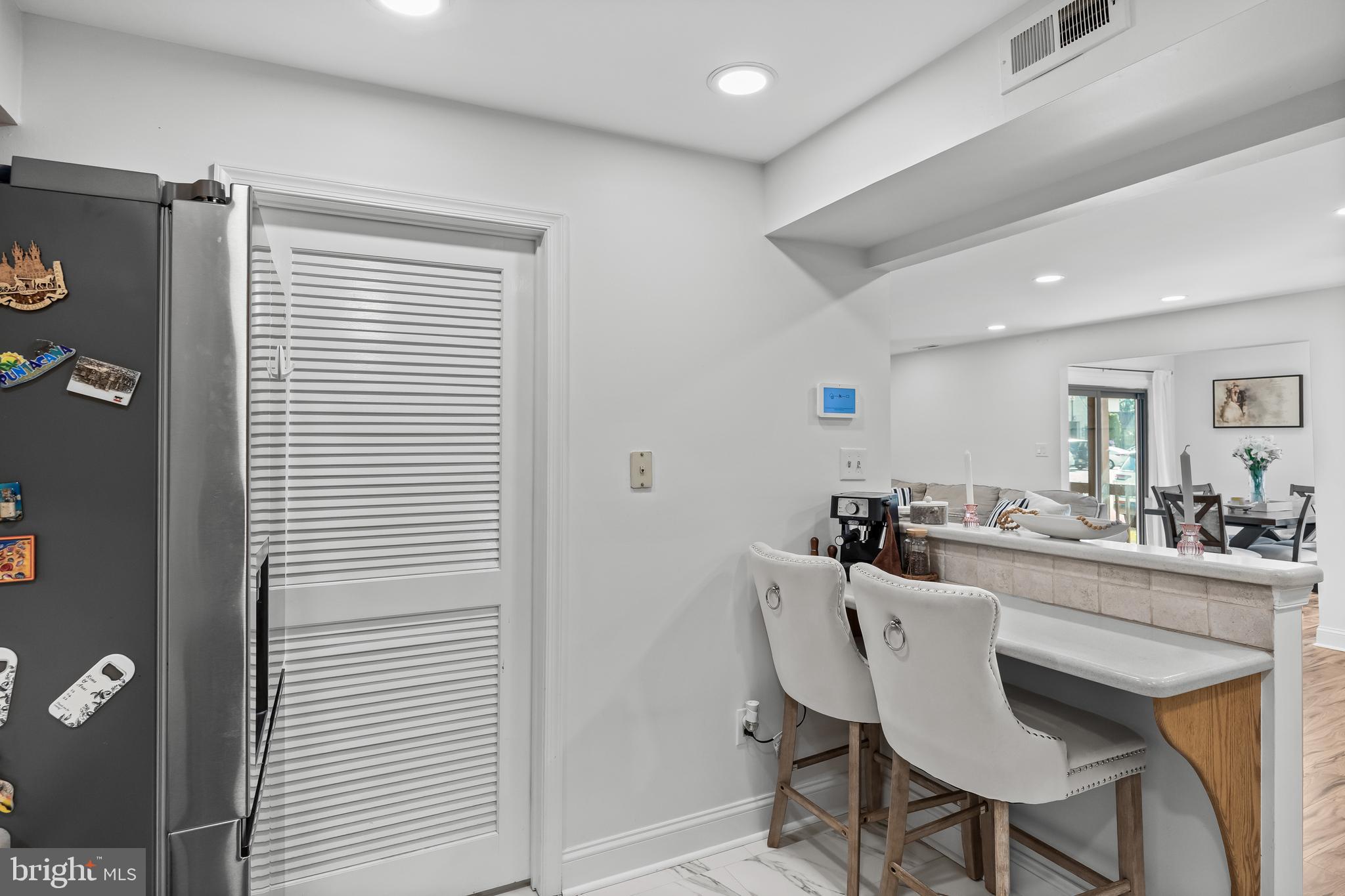 1 Neville Court Sewell, NJ 08080 - Photo 8 of 24 a kitchen with a dining table chairs and a refrigerator