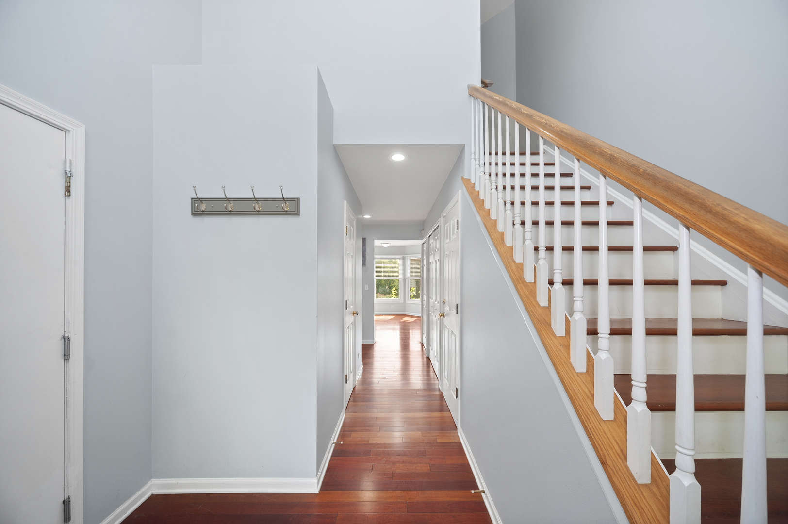 315 Spring Point Drive Carpentersville, IL 60110 - Photo 4 of 21 a view of a hallway with wooden floor and staircase