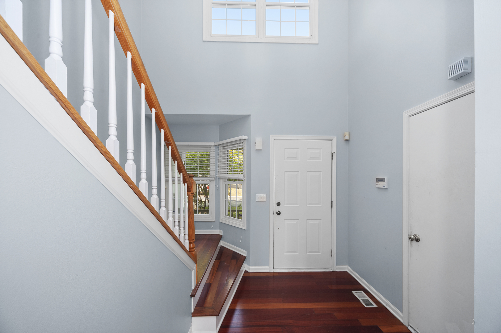315 Spring Point Drive Carpentersville, IL 60110 - Photo 5 of 21 a view of a hallway with wooden floor and staircase