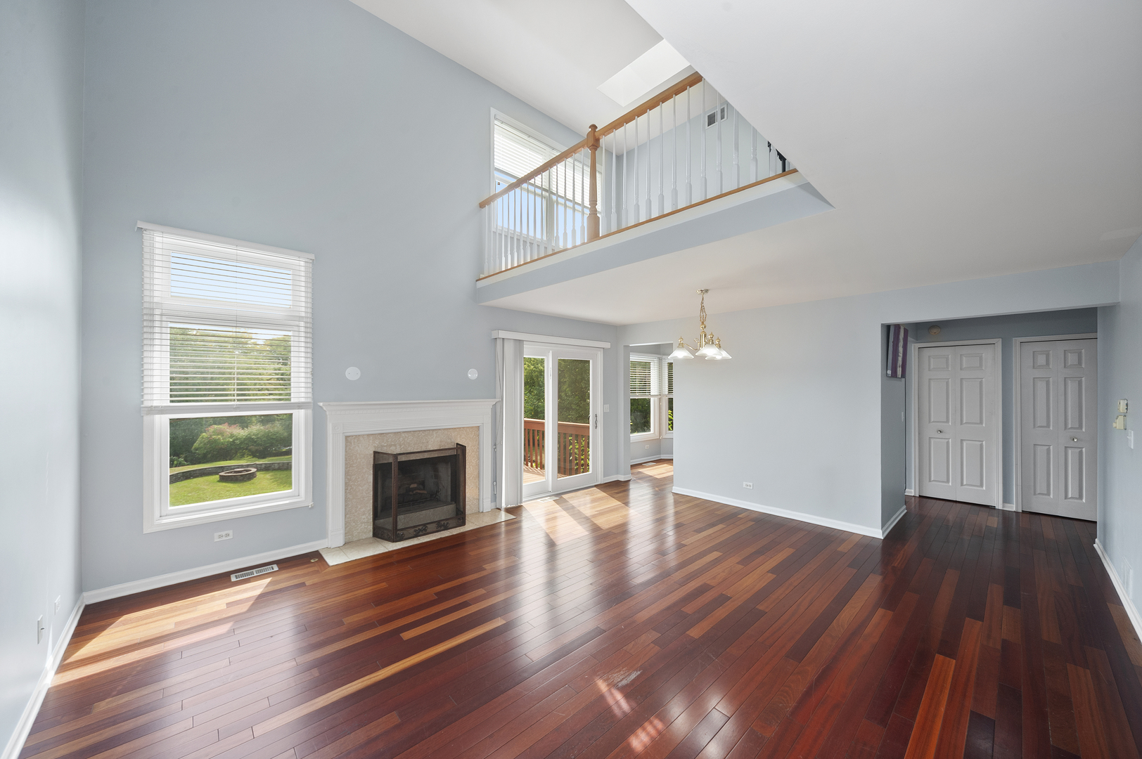 315 Spring Point Drive Carpentersville, IL 60110 - Photo 9 of 21 an empty room with wooden floor fireplace and windows