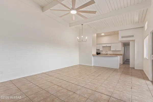 a view of kitchen with kitchen island white cabinets and refrigerator