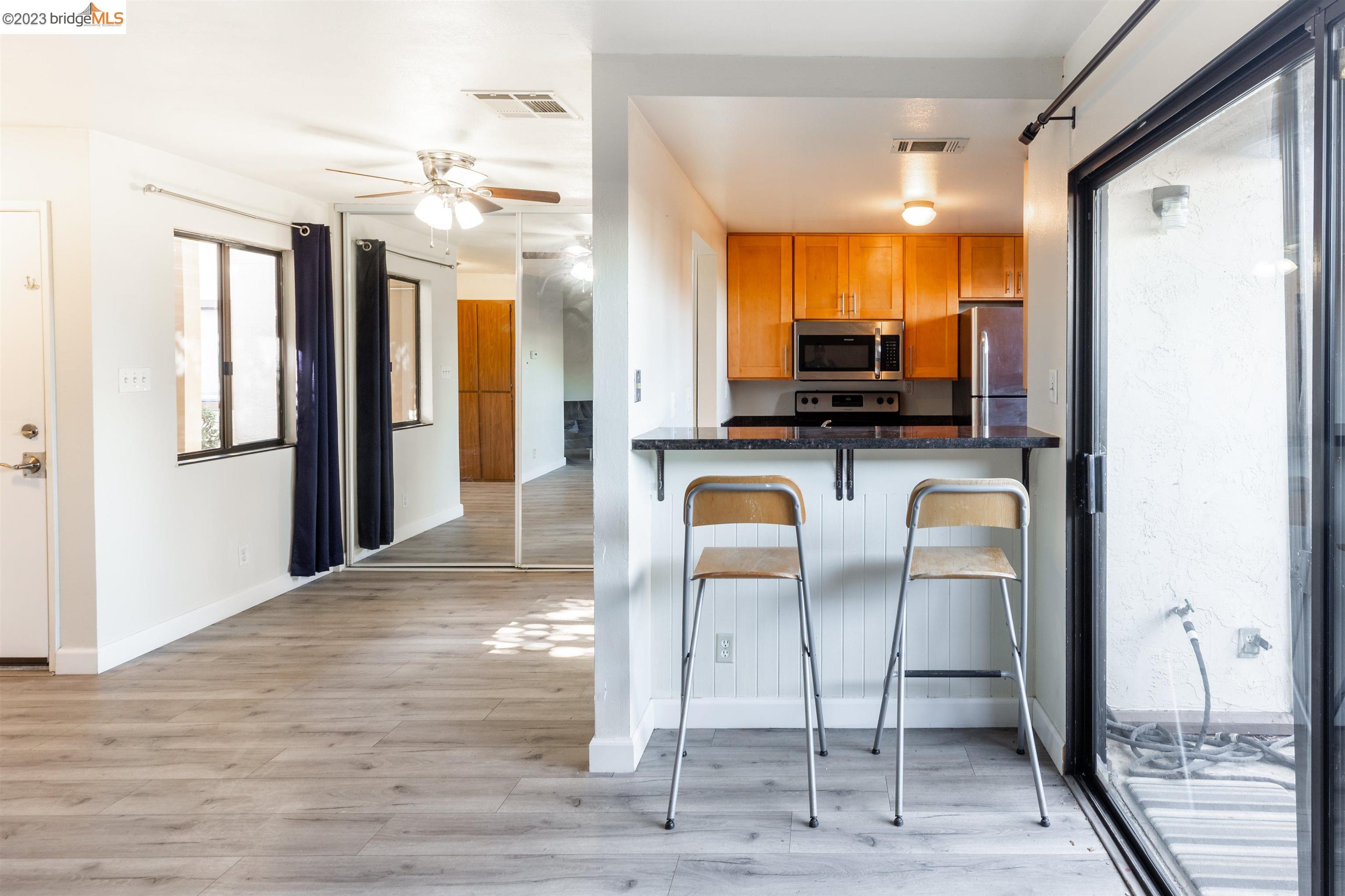 2416 Shadow Lane, Unit 75 Antioch, CA 94509 - Photo 11 of 26 a kitchen with stainless steel appliances kitchen island granite countertop a refrigerator and microwave