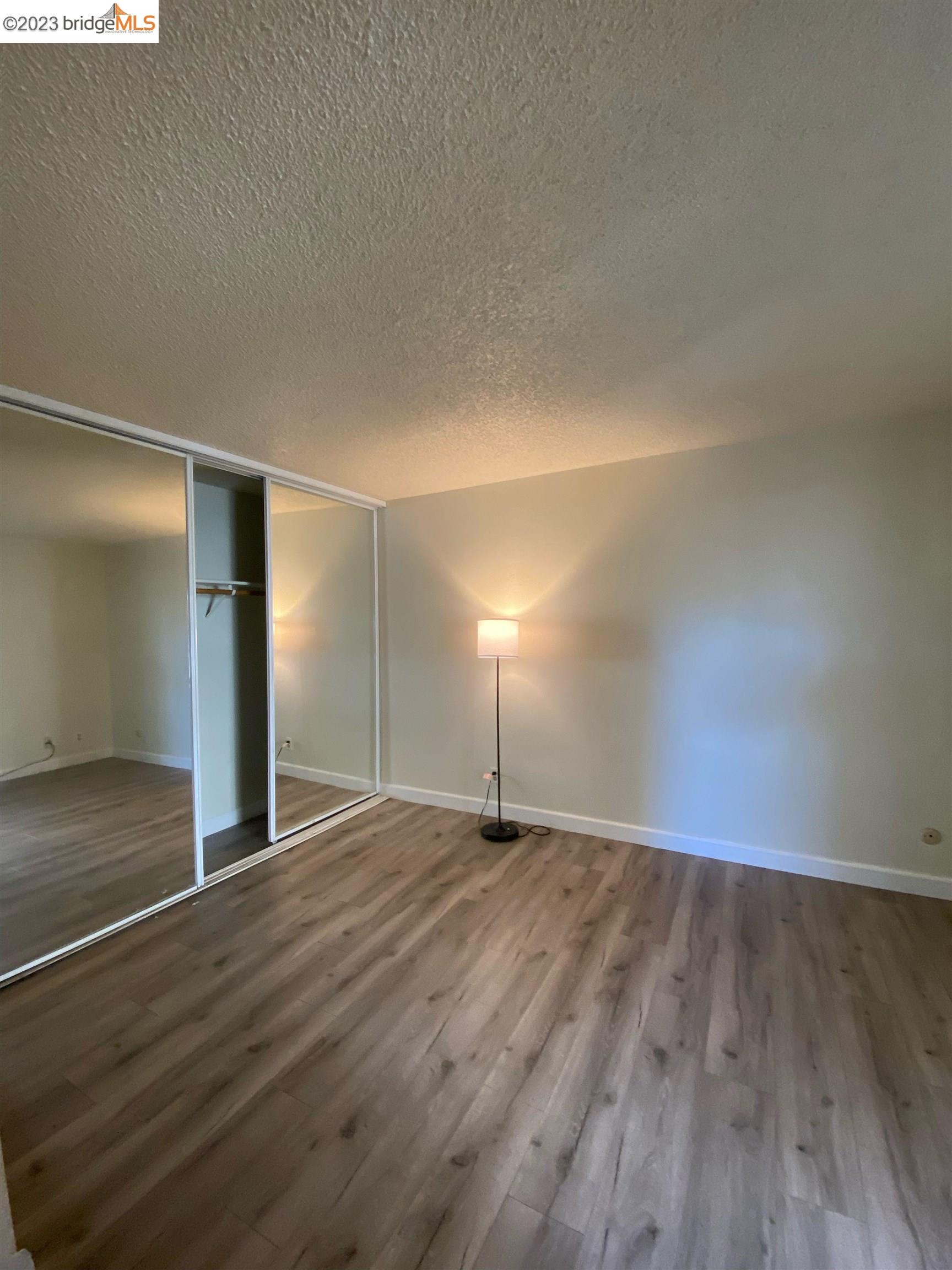 2416 Shadow Lane, Unit 75 Antioch, CA 94509 - Photo 20 of 26 a view of an empty room with wooden floor