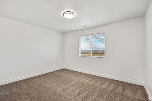 1661 West Ross Road Syracuse, UT 84075 - Photo 22 of 28 Empty room featuring baseboards and carpet flooring