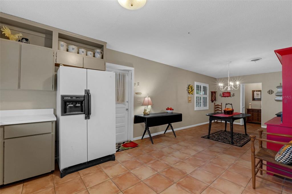 2774 Banchory Road Winter Park, FL 32792 - Photo 11 of 30 a living room with furniture and a dining table with chairs