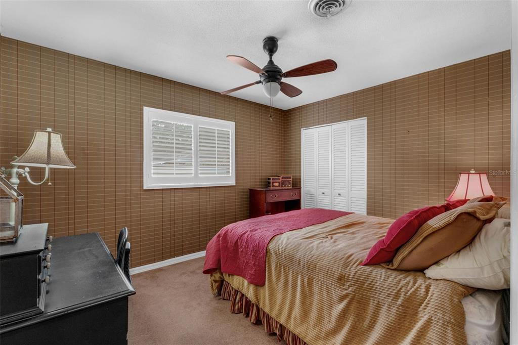 2774 Banchory Road Winter Park, FL 32792 - Photo 17 of 30 a bedroom with a bed and a desk