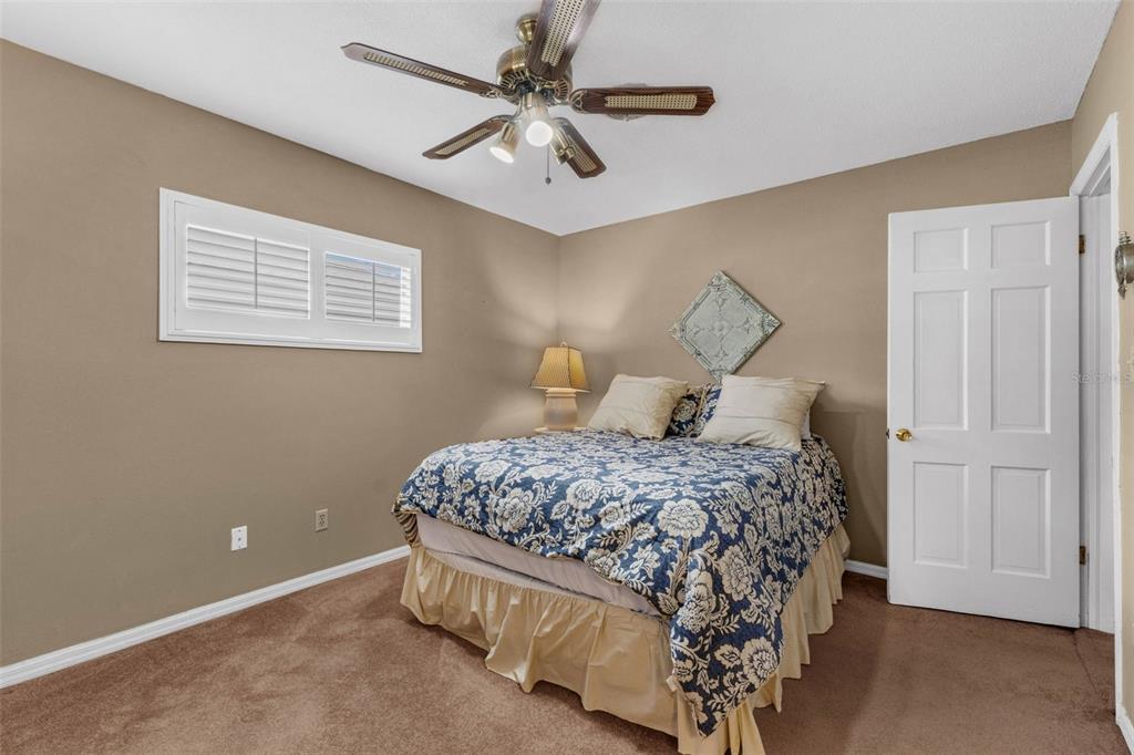 2774 Banchory Road Winter Park, FL 32792 - Photo 20 of 30 a bedroom with a bed and a chandelier