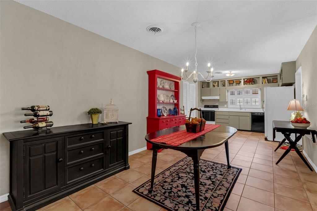 2774 Banchory Road Winter Park, FL 32792 - Photo 7 of 30 a living room with furniture and a chandelier
