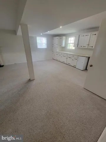 a view of a livingroom with wooden floor and staircase