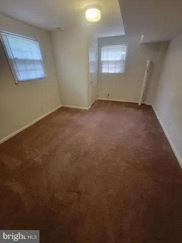 a view of a house with a yard and large tree