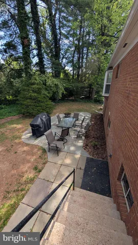 a backyard of a house with table and chairs