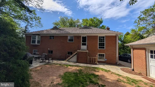 a front view of a house with a garden and garage