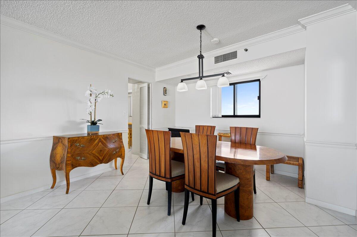 100 Ocean Trail Way, Unit 1403 Jupiter, FL 33477 - Photo 12 of 30 a view of a dining room with furniture