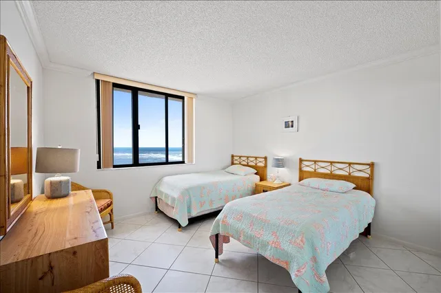 a bedroom with two beds and a window