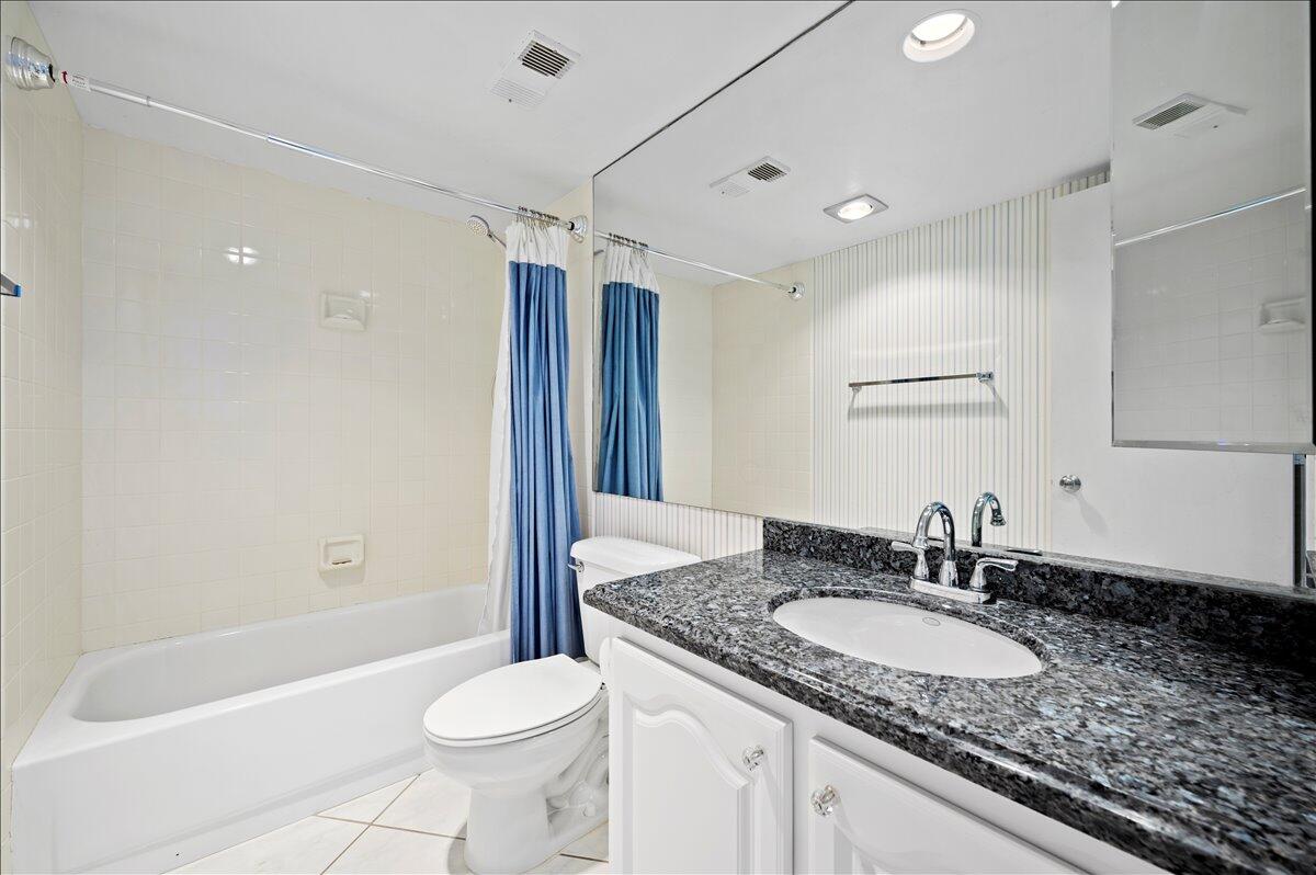 100 Ocean Trail Way, Unit 1403 Jupiter, FL 33477 - Photo 16 of 30 a bathroom with a granite countertop sink toilet and shower