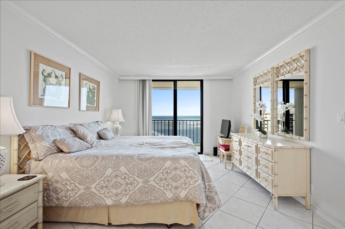100 Ocean Trail Way, Unit 1403 Jupiter, FL 33477 - Photo 20 of 30 a bedroom with a large bed and a window