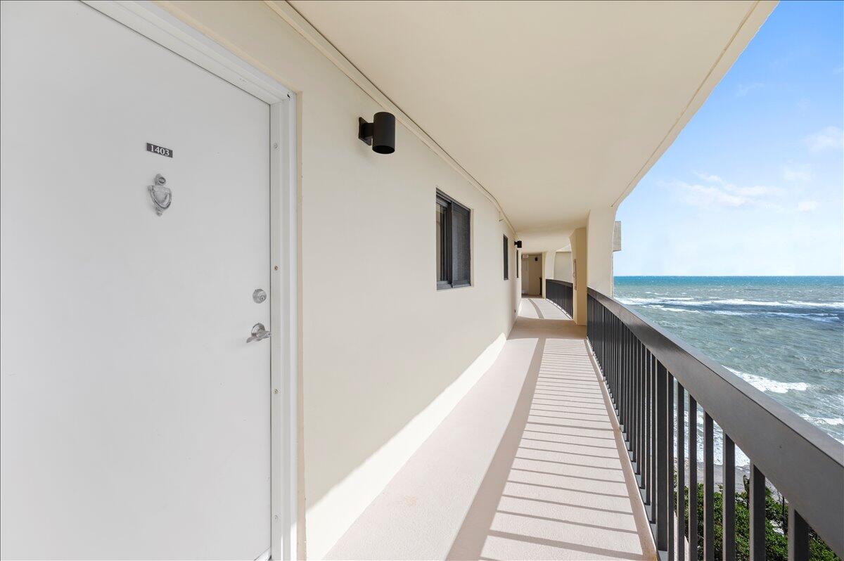 100 Ocean Trail Way, Unit 1403 Jupiter, FL 33477 - Photo 23 of 30 a view of a balcony with wooden floor and staircase