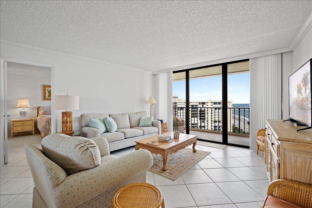 100 Ocean Trail Way, Unit 1403 Jupiter, FL 33477 - Photo 9 of 30 a living room with furniture and a flat screen tv