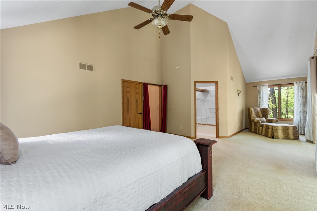 273 Stoner Road Clinton, OH 44216 - Photo 19 of 40 Bedroom with high vaulted ceiling, ceiling fan, and carpet flooring