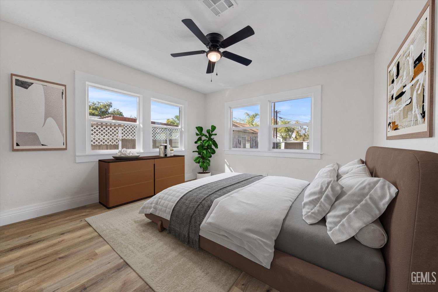 Undisclosed Address Bakersfield, CA 93304 - Photo 12 of 47 a bedroom with a large bed and a large window