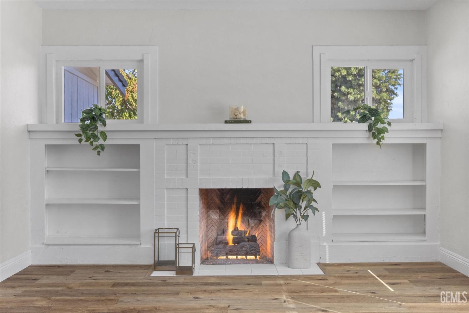 Undisclosed Address Bakersfield, CA 93304 - Photo 16 of 47 a living room with a fireplace and a potted plant