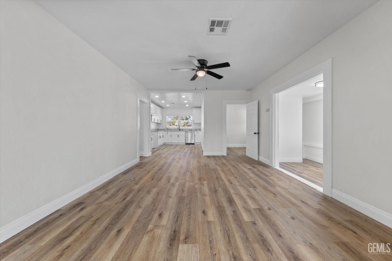 Undisclosed Address Bakersfield, CA 93304 - Photo 20 of 47 wooden floor in an empty room with a window
