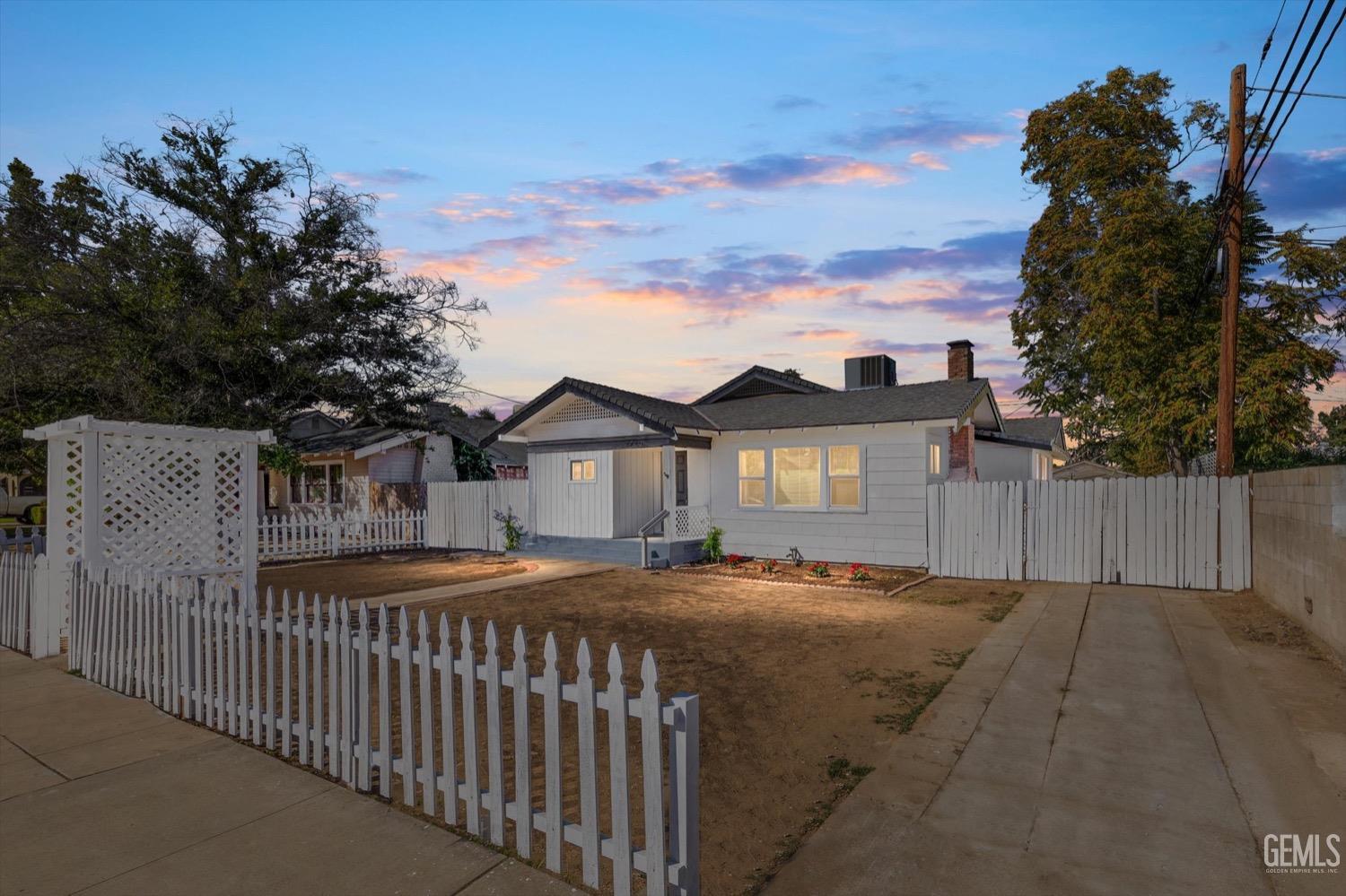 Undisclosed Address Bakersfield, CA 93304 - Photo 2 of 47 a front view of a house with a yard