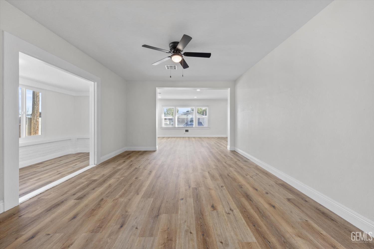 Undisclosed Address Bakersfield, CA 93304 - Photo 21 of 47 wooden floor in an empty room with a window