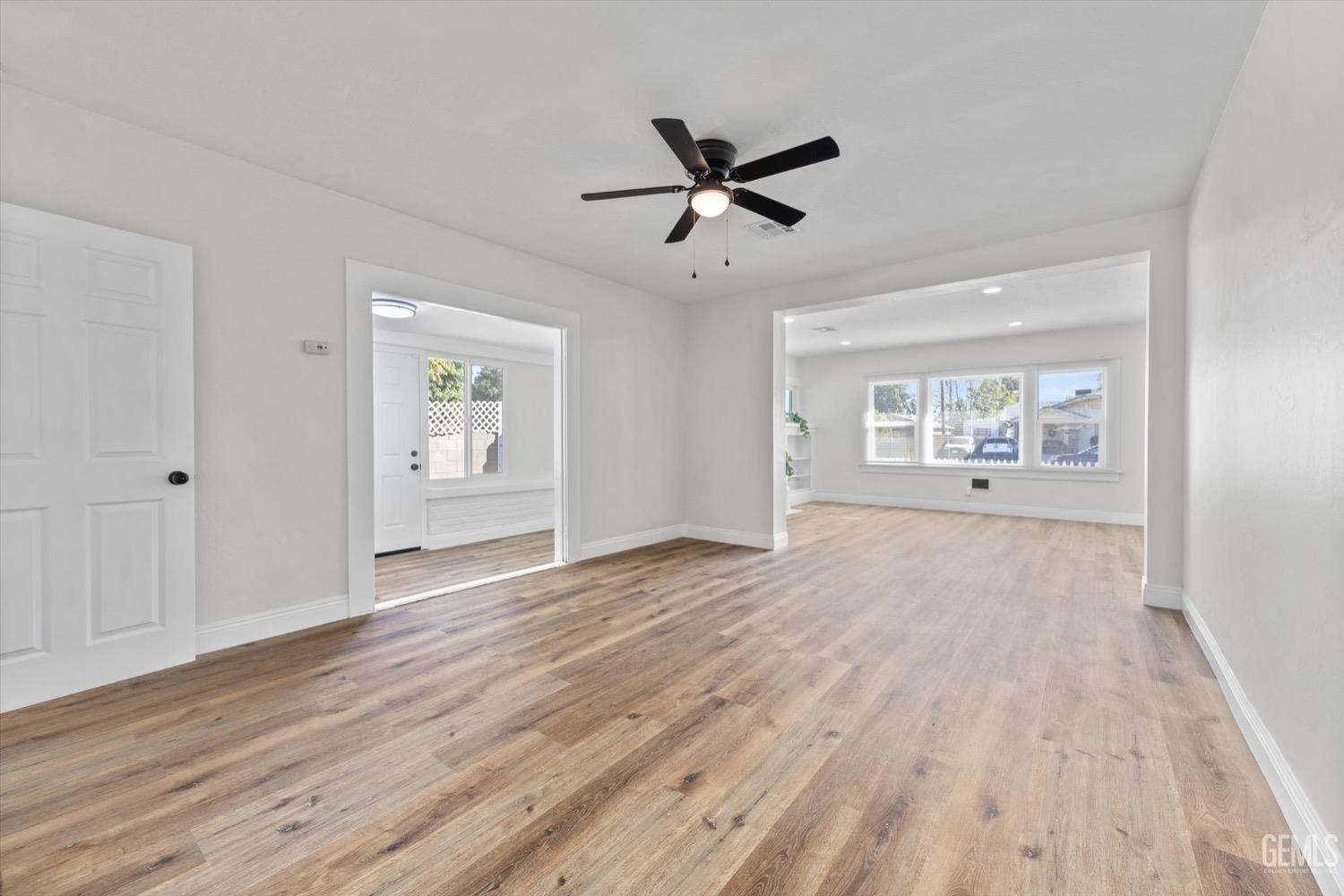 Undisclosed Address Bakersfield, CA 93304 - Photo 22 of 47 a view of an empty room with a window and wooden floor