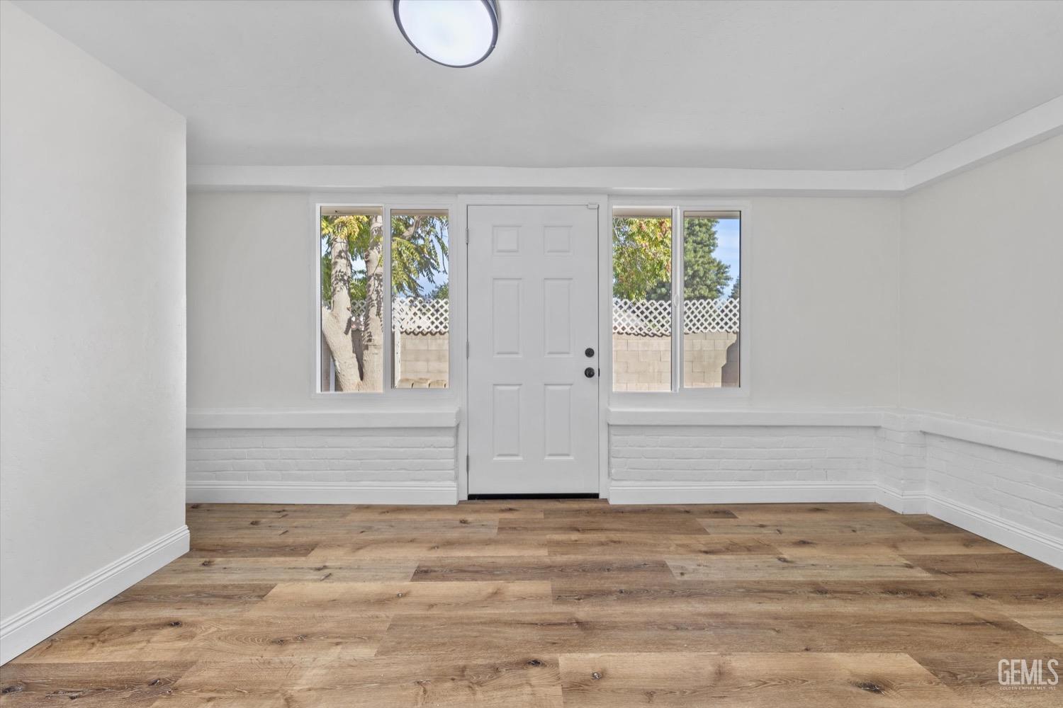 Undisclosed Address Bakersfield, CA 93304 - Photo 23 of 47 a view of empty room with wooden floor and fan
