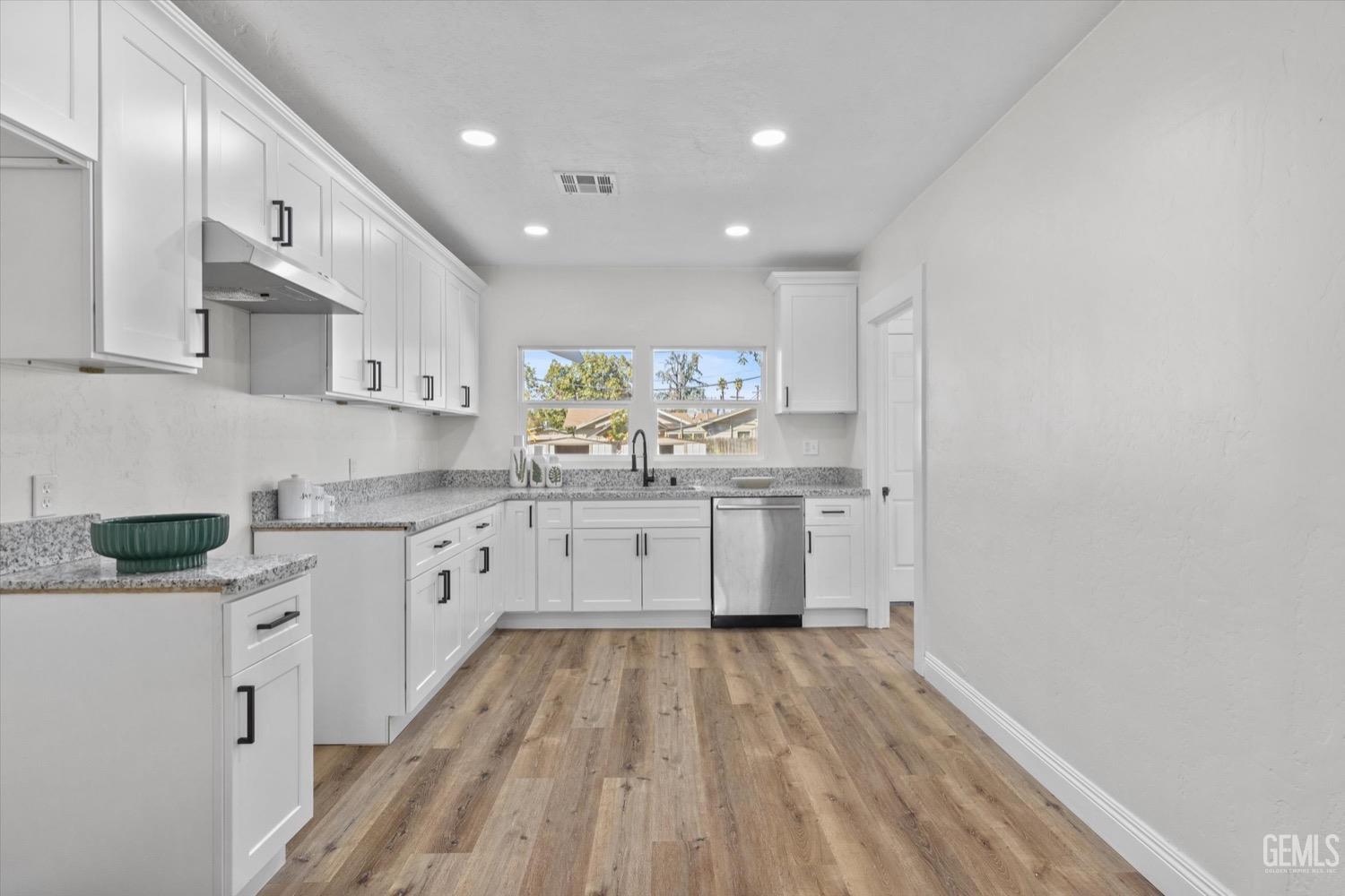 Undisclosed Address Bakersfield, CA 93304 - Photo 25 of 47 a kitchen with granite countertop a sink cabinets window and stainless steel appliances
