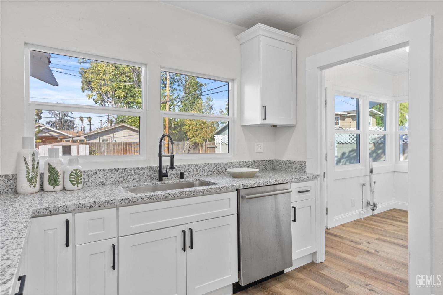 Undisclosed Address Bakersfield, CA 93304 - Photo 27 of 47 a kitchen with stainless steel appliances granite countertop a sink and cabinets with wooden floor