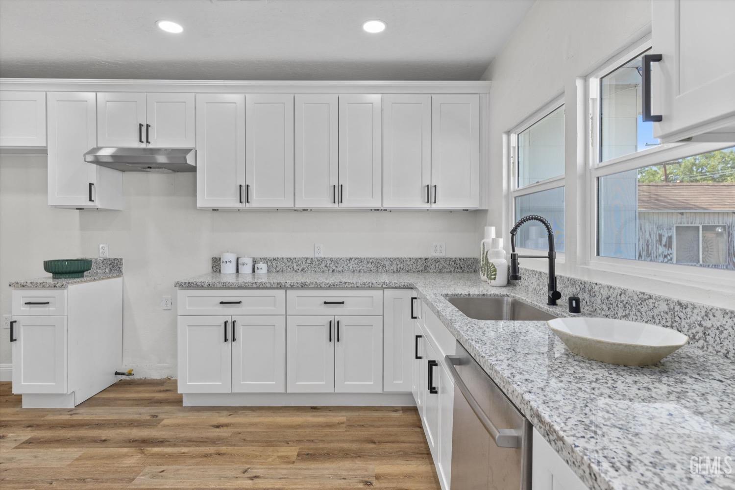 Undisclosed Address Bakersfield, CA 93304 - Photo 28 of 47 a kitchen with granite countertop a sink stove and cabinets
