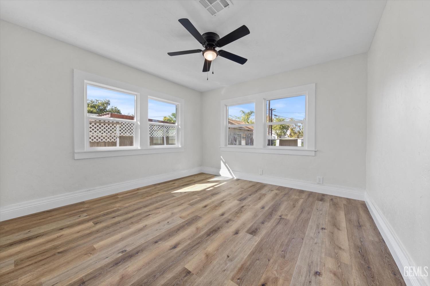Undisclosed Address Bakersfield, CA 93304 - Photo 29 of 47 a view of empty room with wooden floor and fan