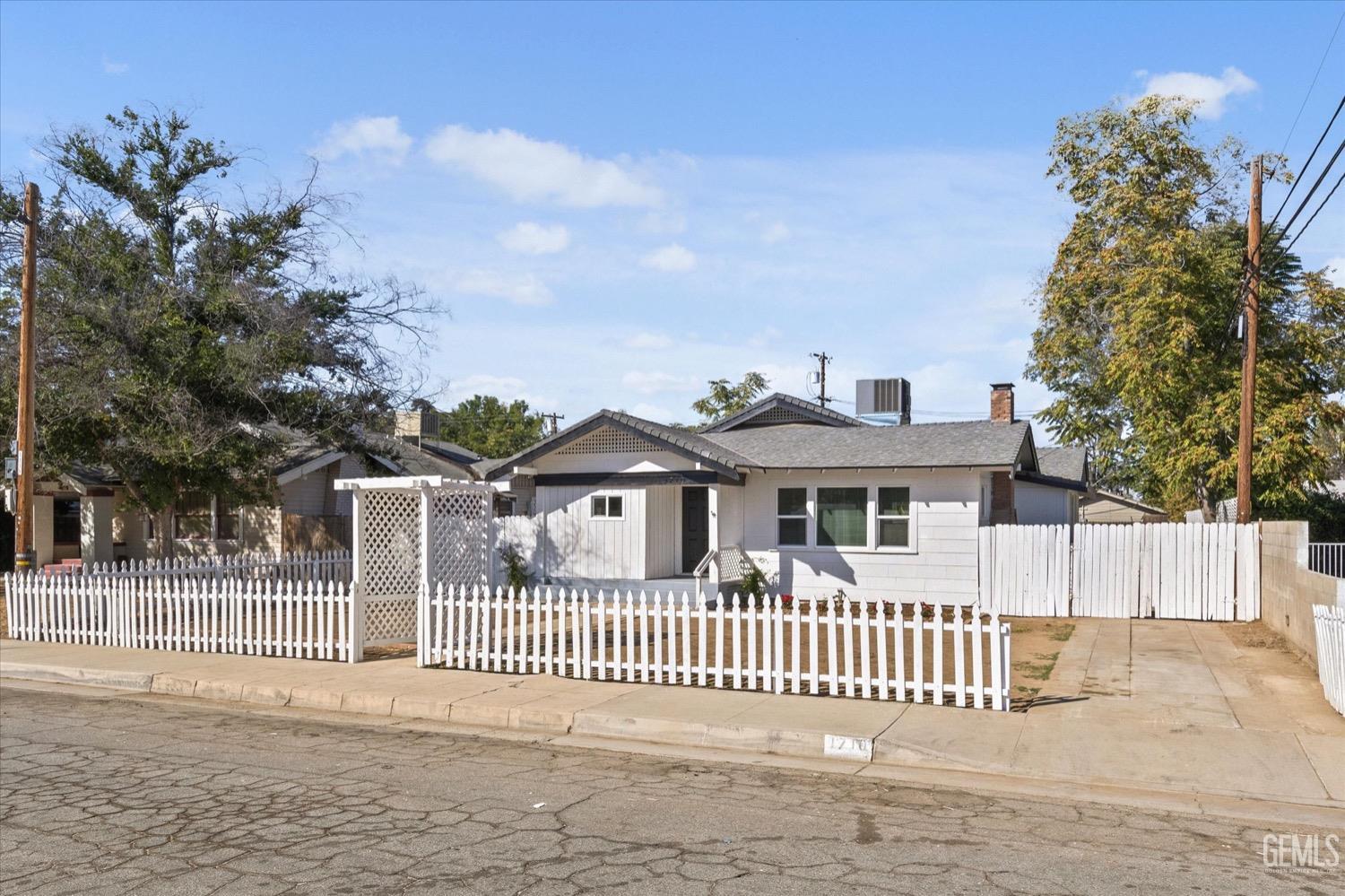 Undisclosed Address Bakersfield, CA 93304 - Photo 3 of 47 a front view of a house with a garden