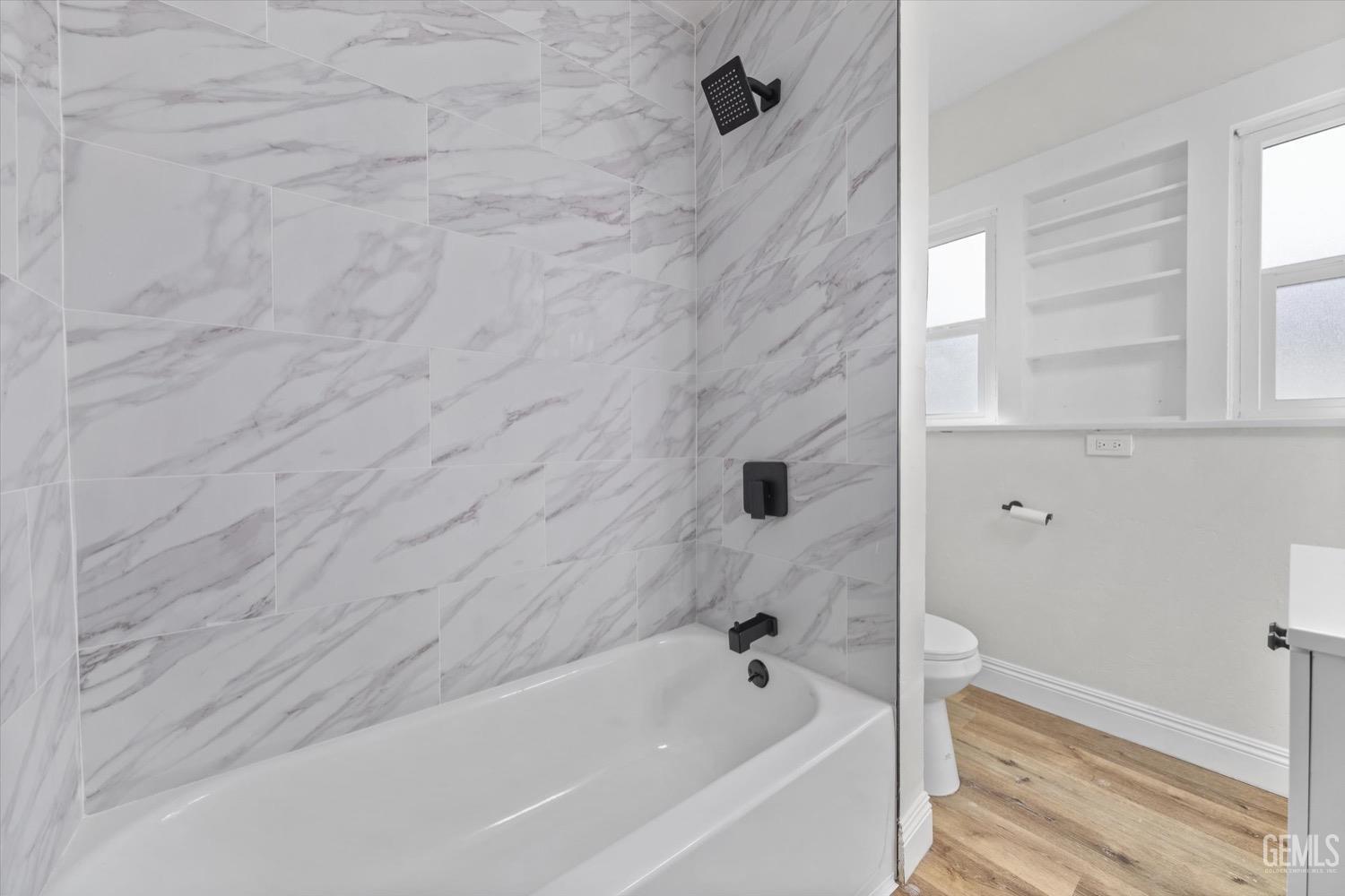 Undisclosed Address Bakersfield, CA 93304 - Photo 35 of 47 a bathroom with a bathtub