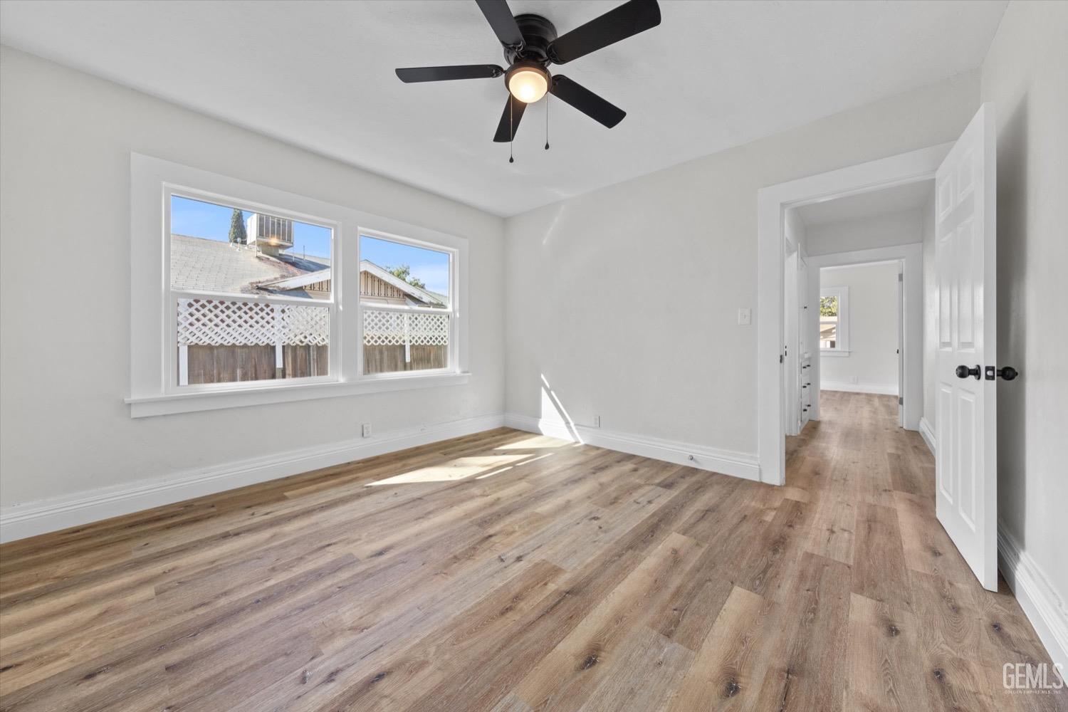 Undisclosed Address Bakersfield, CA 93304 - Photo 37 of 47 a view of empty room with wooden floor and fan