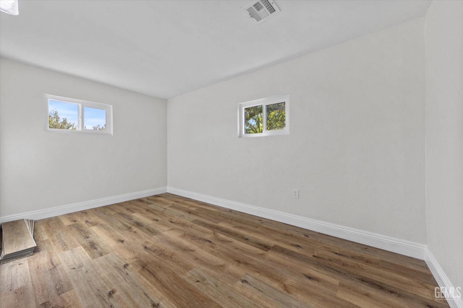 Undisclosed Address Bakersfield, CA 93304 - Photo 38 of 47 a view of empty room with wooden floor