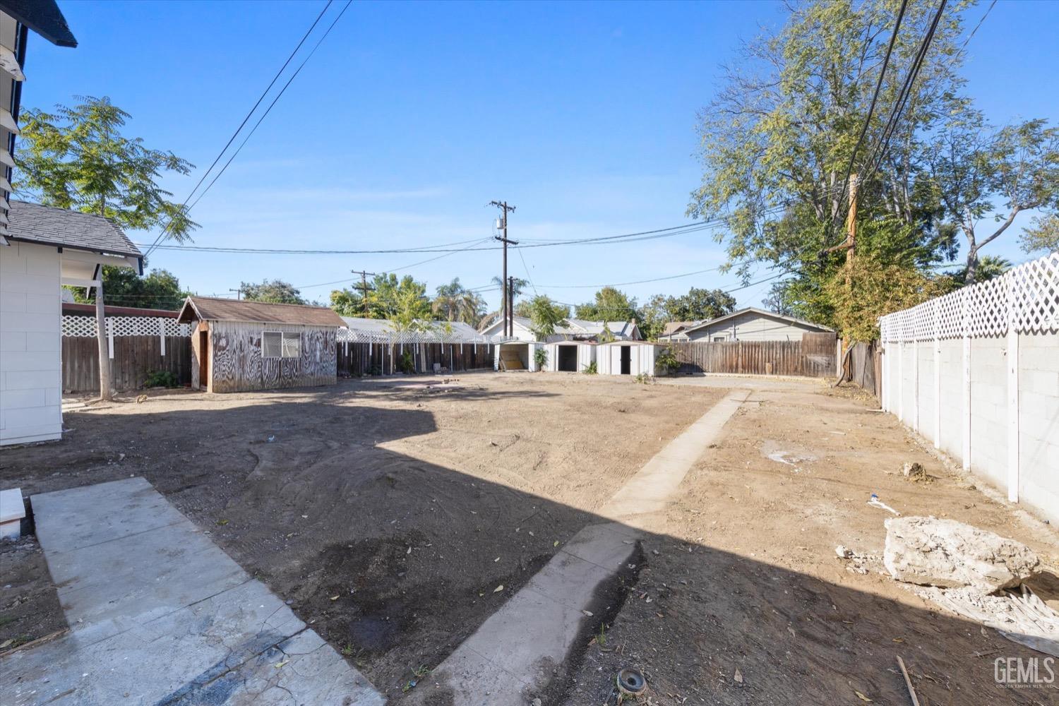 Undisclosed Address Bakersfield, CA 93304 - Photo 43 of 47 a view of a white house with a yard