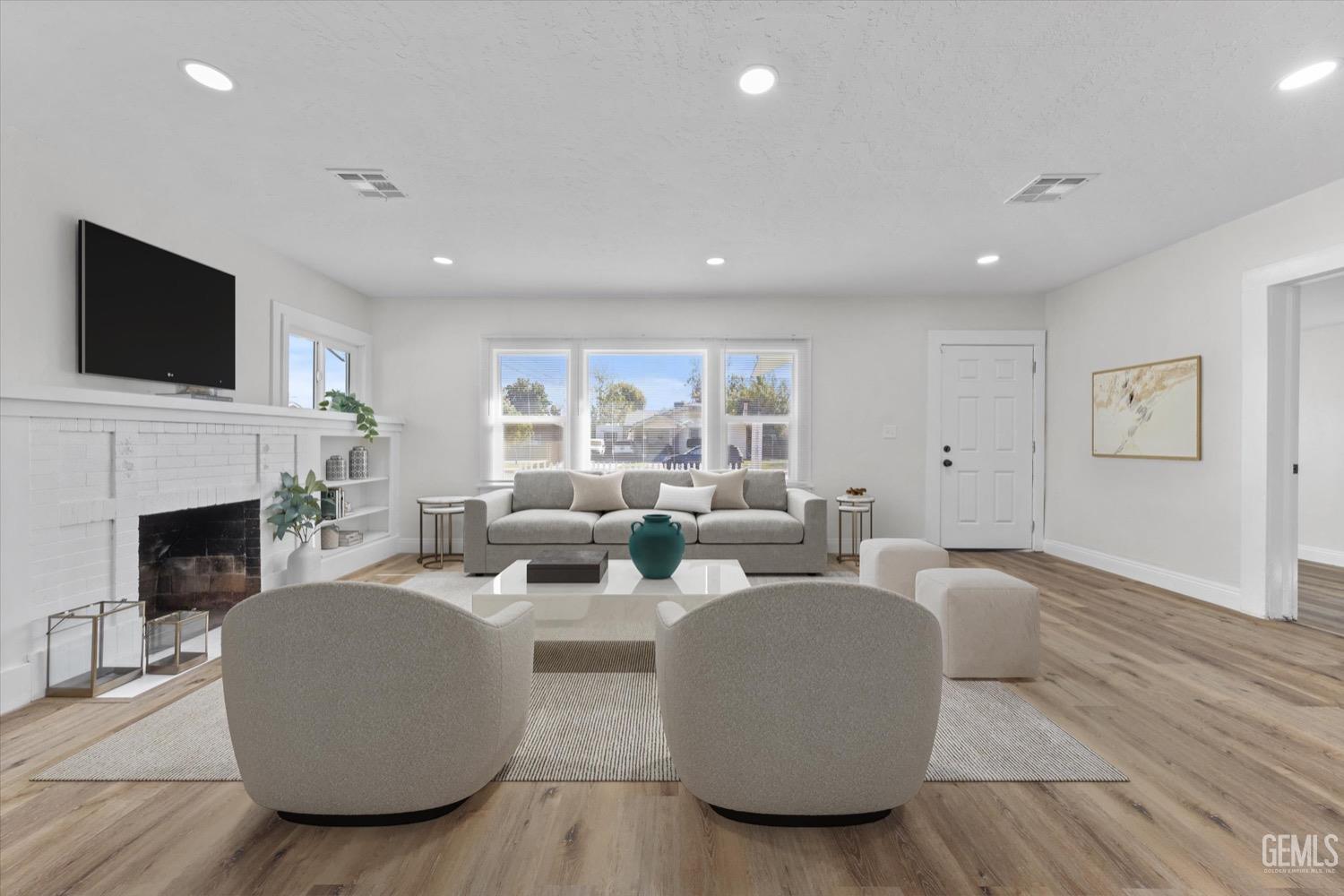 Undisclosed Address Bakersfield, CA 93304 - Photo 6 of 47 a living room with fireplace furniture and a flat screen tv