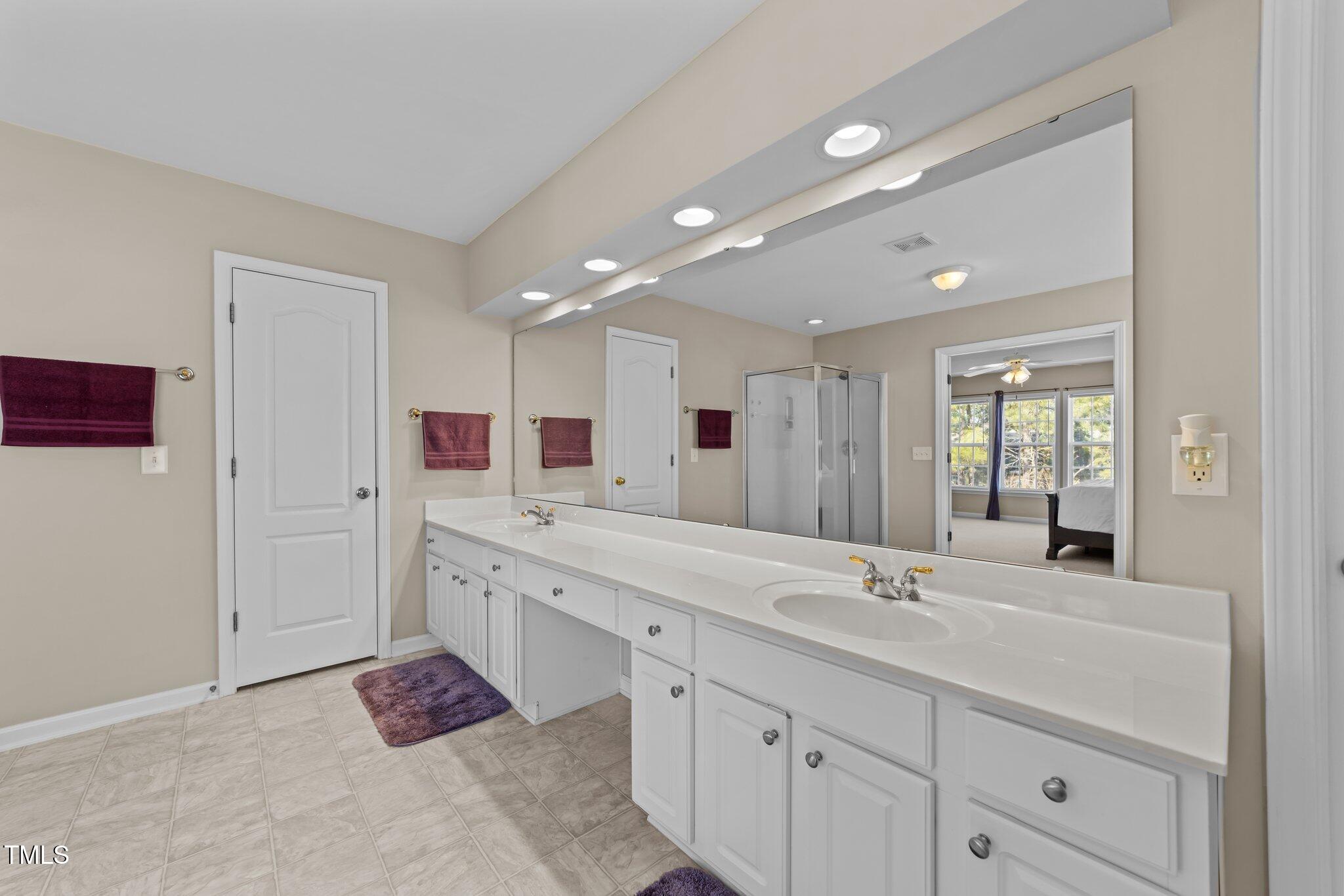 5430 Wind Mountain Lane Raleigh, NC 27613 - Photo 26 of 48 a spacious bathroom with a double vanity sink mirror and double