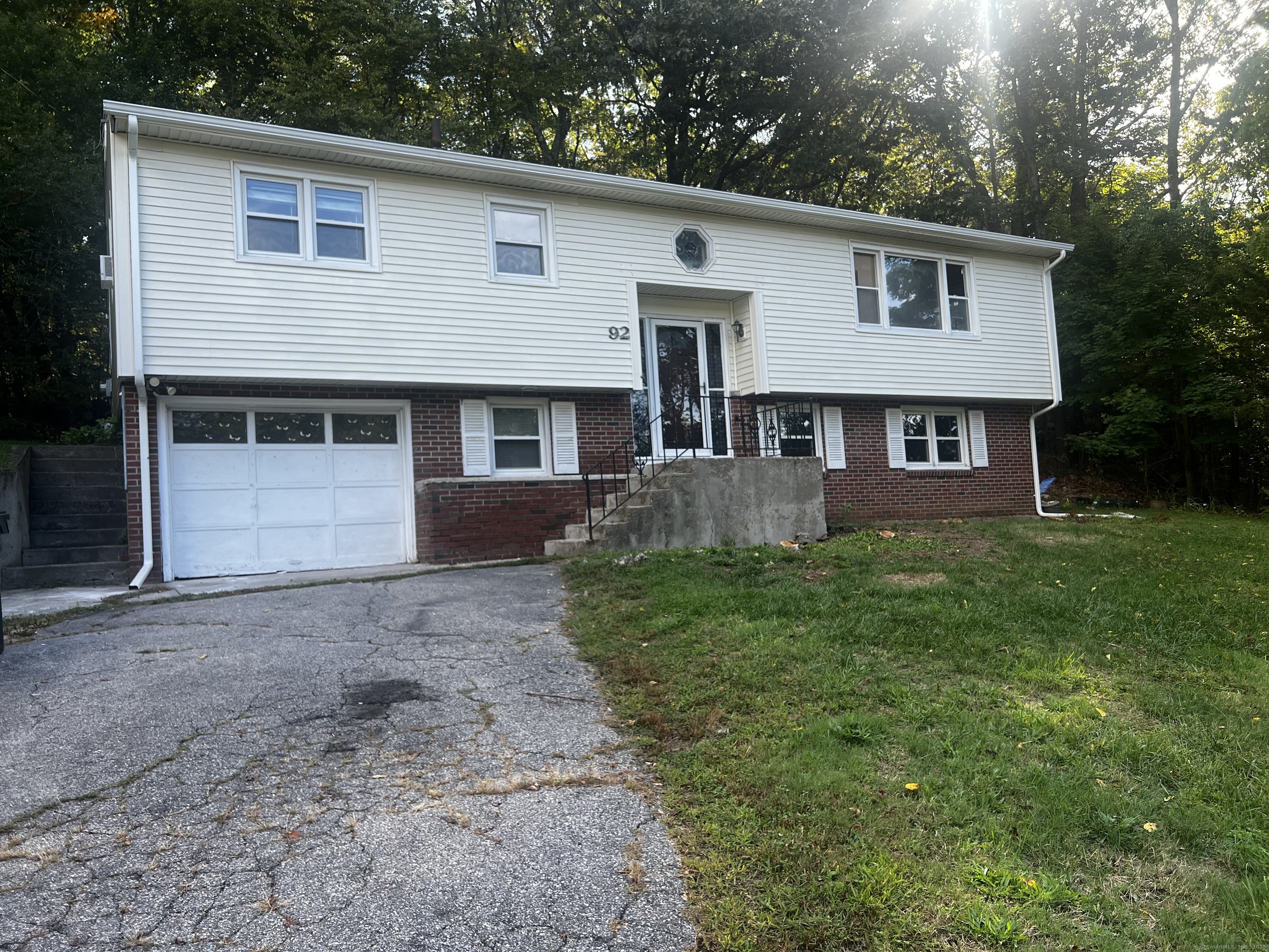 92 Lucas Park Road Norwich, CT 06360 - Photo 1 of 1 a front view of a house with a yard and garage