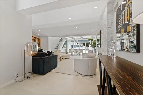 a living room with furniture and a mirror