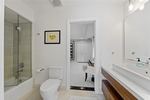 a kitchen with stainless steel appliances kitchen island granite countertop a refrigerator and a sink