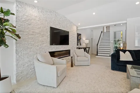 a view of a house with pool and sitting area