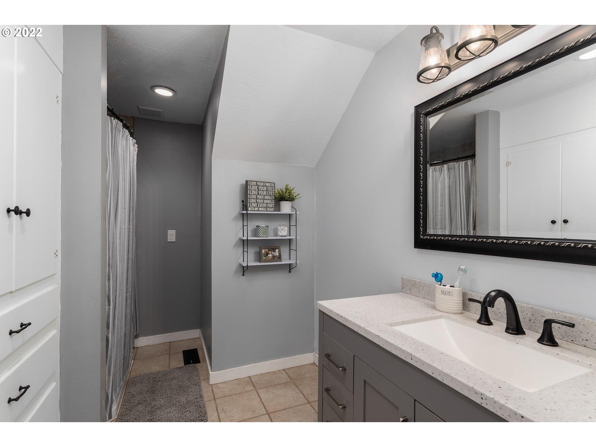 12275 Southeast School Avenue Boring, OR 97009 - Photo 14 of 14 a bathroom with a sink vanity granite and a mirror