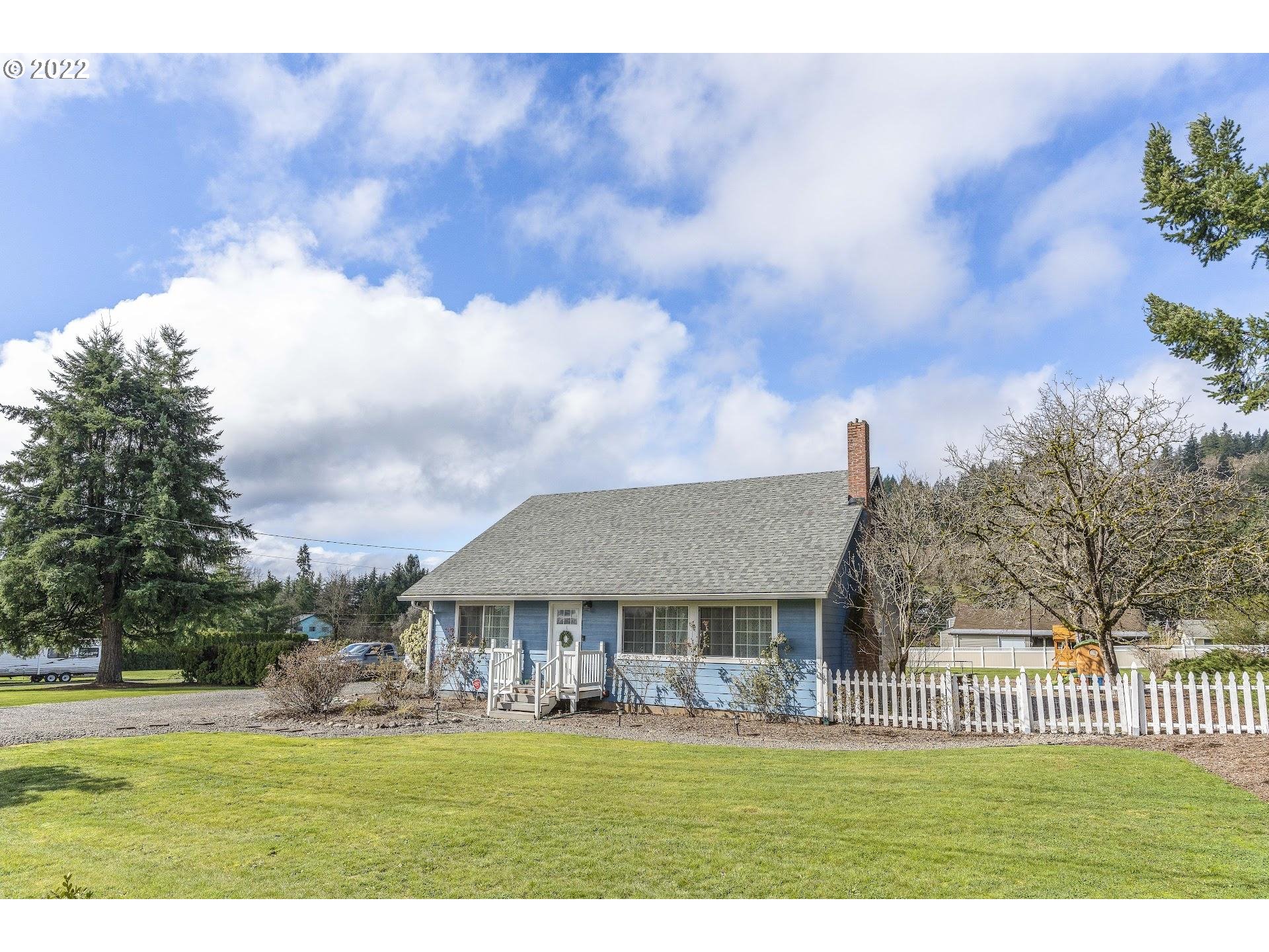 12275 Southeast School Avenue Boring, OR 97009 - Photo 2 of 14 a view of a big house with a big yard and large trees